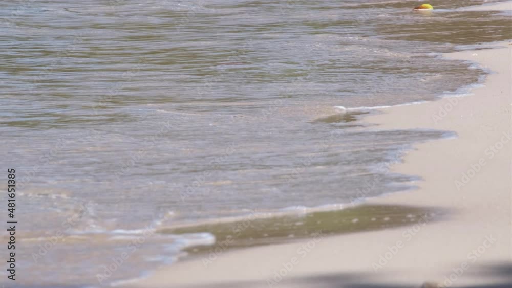 medium close up of white sand beach with ocean gently lapping on sand medium close up of white sand beach with ocean gently lapping on sand