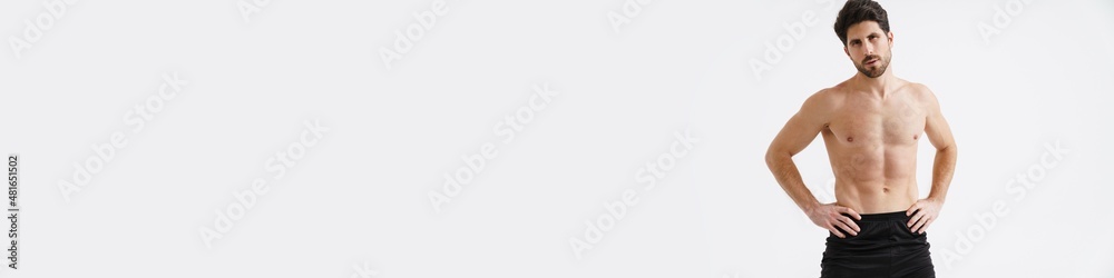 Shirtless athletic sportsman posing and looking at camera Shirtless athletic sportsman posing and looking at camera