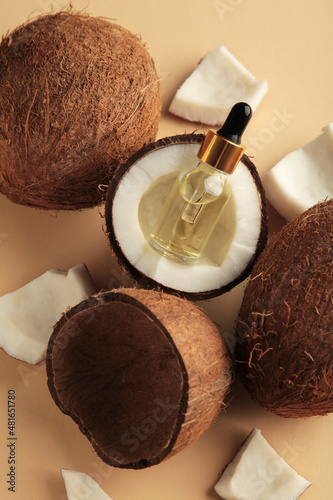 Quadro su tela Coconut oil with coconut on beige background. Top view