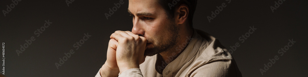 Fototapeta premium Tired bored mid aged brunette man looking at laptop