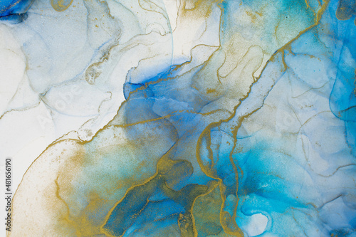 Rich bright abstract picture. Luxury abstract fluid art painting alcohol ink. Background blue green gold sparkles.