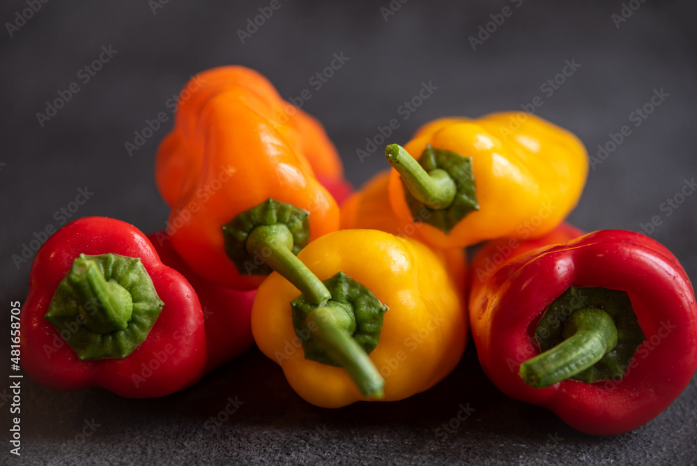 Colorful long sweet peppers on dark background Colorful long sweet peppers on dark background