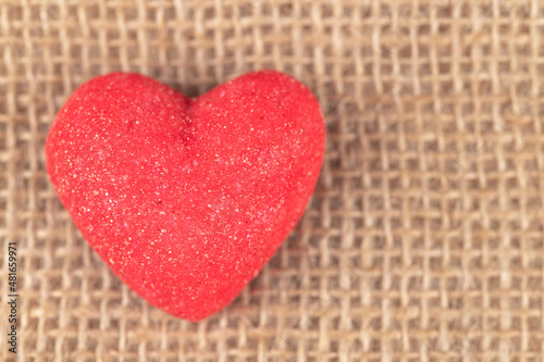 Red heart shape marshmallow in a sackcloth background