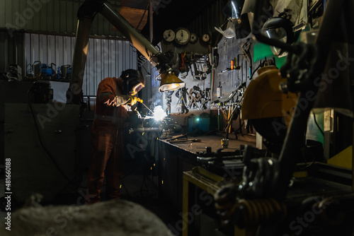 A welder at work in his workshop. 