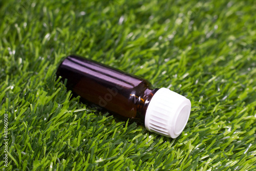 Essential oil in bottles on the grass, spa