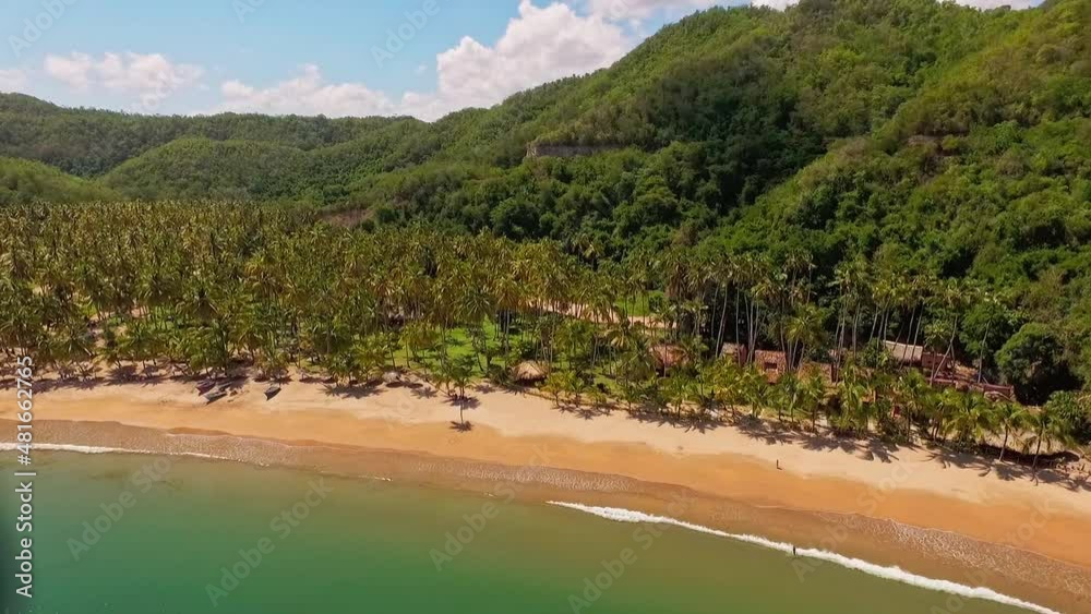 Aerial view of the venezuelan caribbean sea in the morning near the coast with cliffs and of evergreen forest, next to a tropical beach with palm trees and beige sand, under a clear sky with clouds
Aerial view of the venezuelan caribbean sea in the morning near the coast with cliffs and of evergreen forest, next to a tropical beach with palm trees and beige sand, under a clear sky with clouds