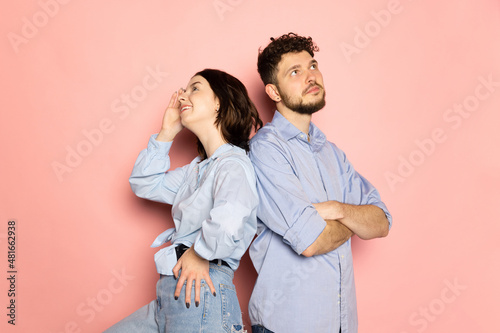 Married couple of young and happy man and woman isolated on pink trendy color background. Human emotions, youth, love and lifestyle concept