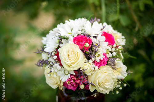 
Bouquet of flowers from roses and daisies, flowers for the day of everything, wedding bouquet, flowers for the bride, wedding accessories.