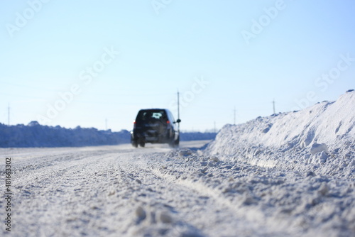 Road cleared of snow on a sunny winter day