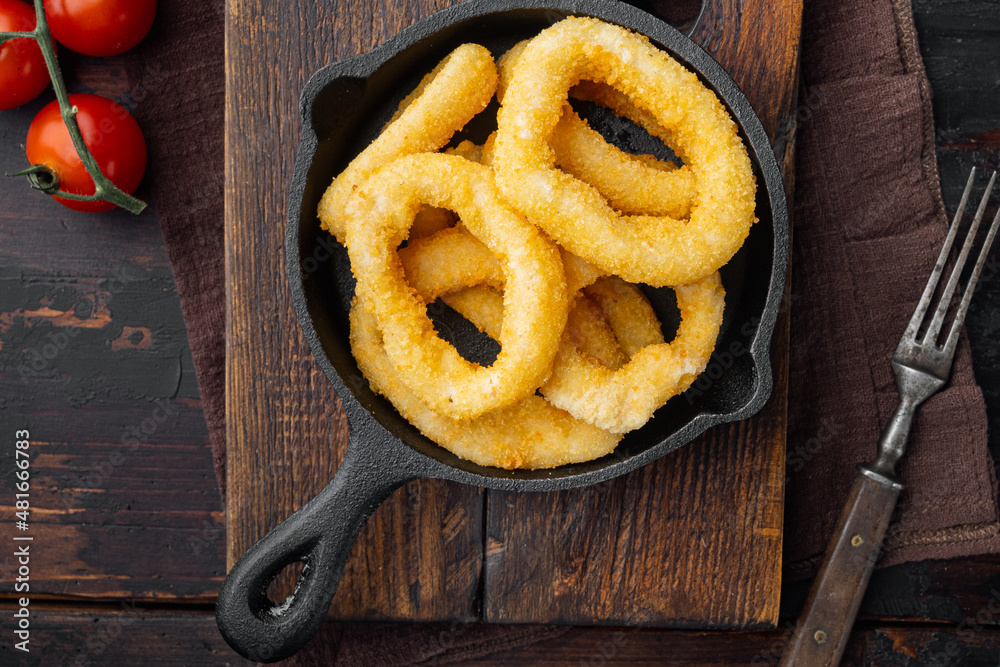 Fried squid rings. roast seafood snack on cast iron frying pan skillet