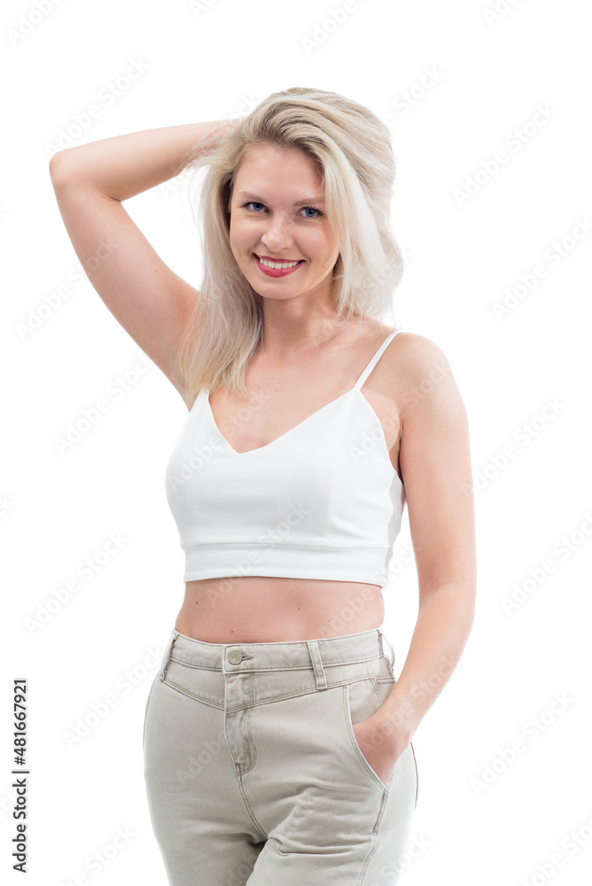 Beautiful blonde in jeans in the studio on a light background.