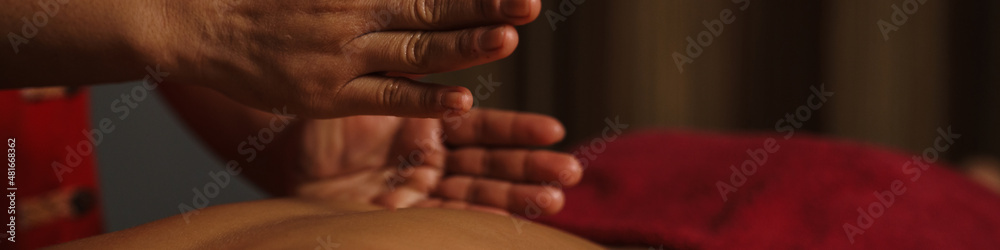 Professional masseuse doing massage in spa indoors