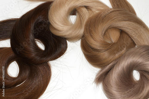 Hair samples for extension rolled up different colors.White background.