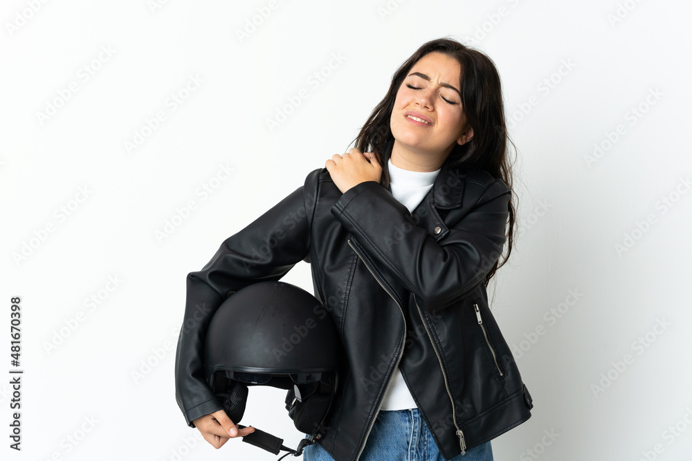 Woman holding a motorcycle helmet isolated on white background suffering from pain in shoulder for having made an effort Woman holding a motorcycle helmet isolated on white background suffering from pain in shoulder for having made an effort