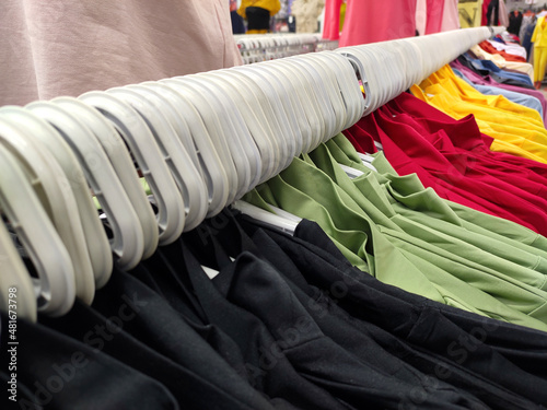 Variety of casual shirts on hangers..