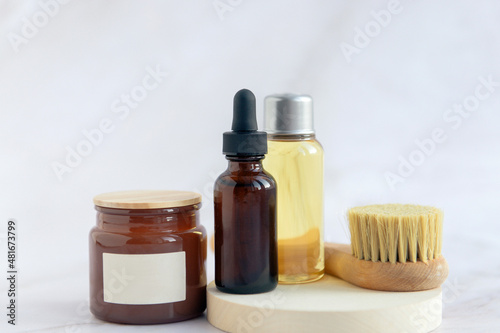 cosmetics products in bathroom - serum dropped bottle  face brush  candle and aroma oil