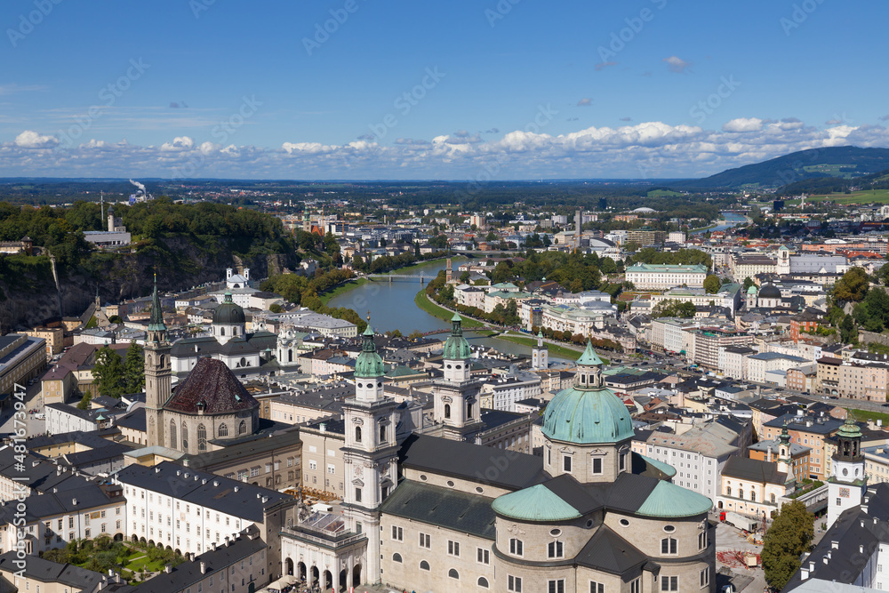 Panorama from high angle view of urban scenery with famous Historic Centre (Altstadt) in Salzburg, Austria. Sunny day, blue sky, clouds. Austrian ancient historical monuments. Touristic destination.