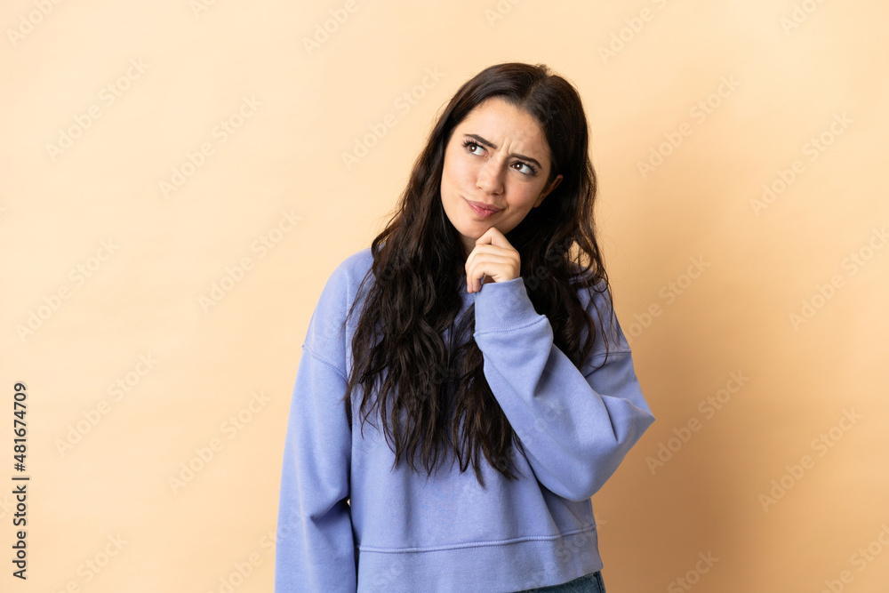 Young caucasian woman over isolated background and looking up Young caucasian woman over isolated background and looking up