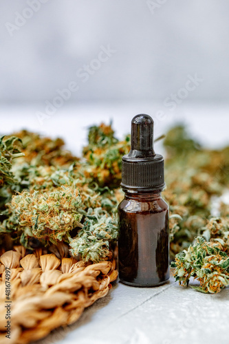 Cannabis buds in hand on yellow background Background for Copy space. Blunt and Lighters. Herb grinder Fresh marihuana. CBD and THC on buds in cannabis. Hemp legalisation. Close up.