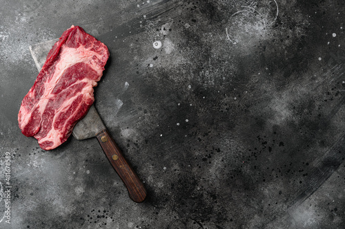 Fresh  chuck roll steak, on black dark stone table background, top view flat lay, with copy space for text