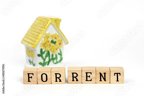 For Rent property Concept. Buy Rent word is written on wood block and model house on white background. 