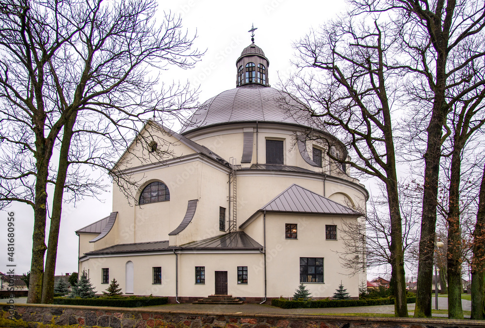 Built in 1933-75, the Catholic Church of the Assumption of the Blessed Virgin Mary in Hodyszewo in Podlasie, Poland. The photos show a general view of the temple and its architectural details.