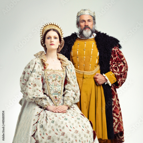 Stern and regal. Studio shot of a regal king and queen. photo