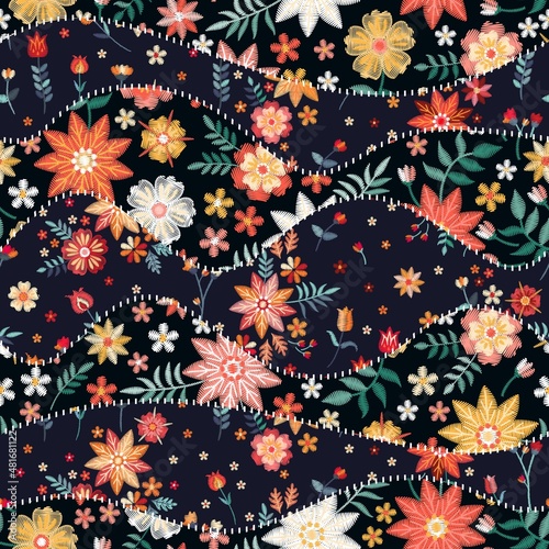 Seamless patchwork pattern of wavy patches with embroidery flowers. Beautiful needlework. Vector illustration.