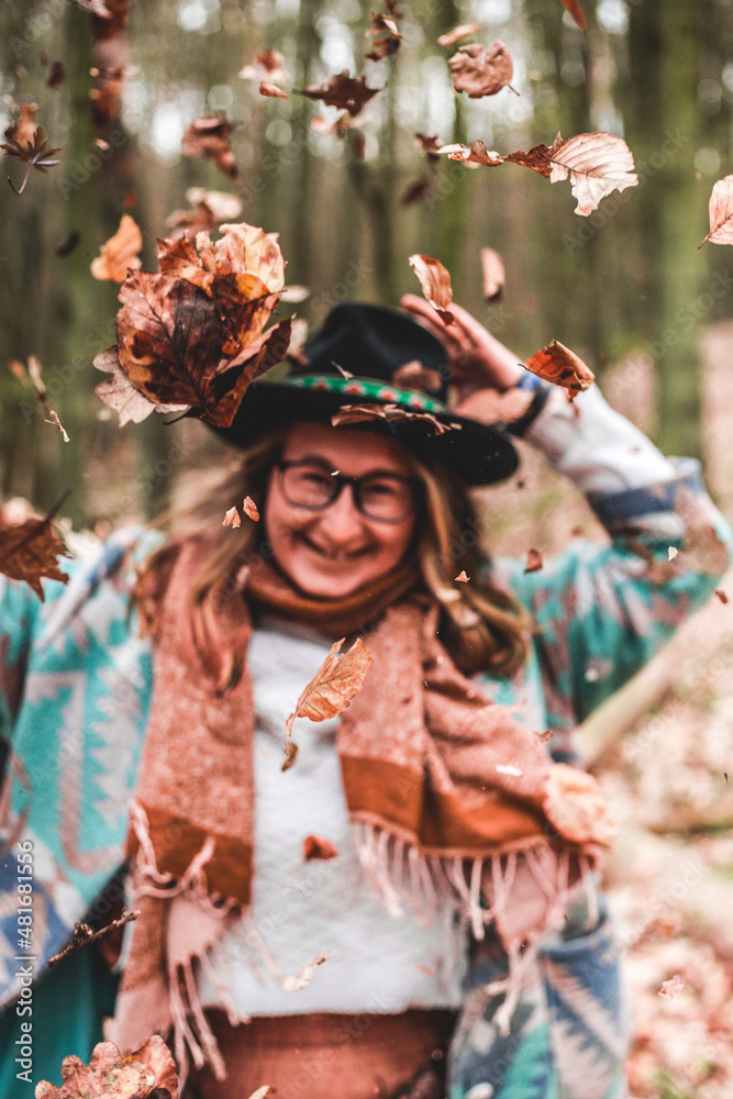 Portrait of a girl in the autumn leaves