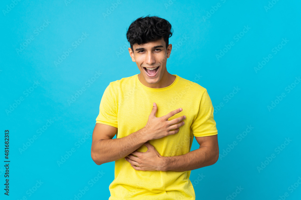 Young Argentinian man isolated on background smiling a lot Young Argentinian man isolated on background smiling a lot