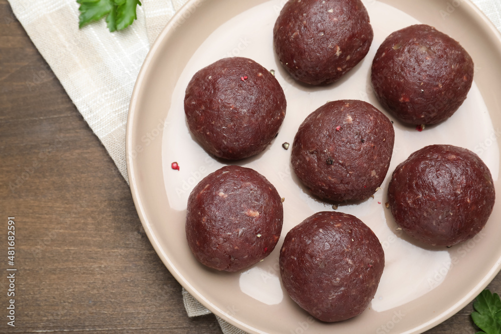 Many fresh raw meatballs on wooden table, flat lay Many fresh raw meatballs on wooden table, flat lay