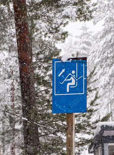 Ski lift in winter season. Information sign about safety on the ski lift.