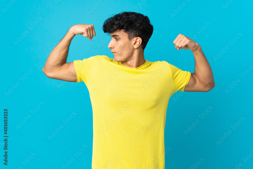 Young Argentinian man isolated on background doing strong gesture Young Argentinian man isolated on background doing strong gesture
