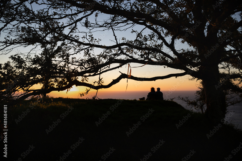 A couple enjoys the sunset from the Celtic fort of Santa Tecla in A Guarda