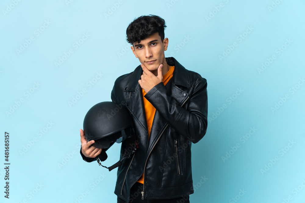 Argentinian man with a motorcycle helmet thinking Argentinian man with a motorcycle helmet thinking