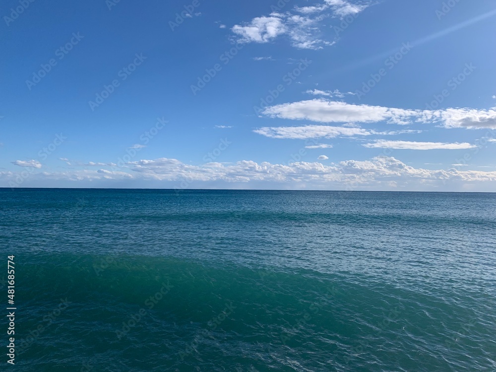 Perfect line of the sea horizon, deep blue sea surface and blue sky
