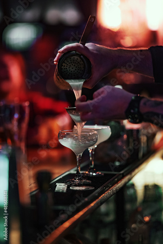 bartender pours a cocktail	
