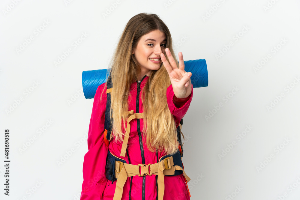 Young mountaineer woman with a big backpack over isolated background happy and counting three with fingers Young mountaineer woman with a big backpack over isolated background happy and counting three with fingers