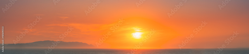 Aegean Sea. Evening Sun Sunshine Above Sea. Natural Sunset Sky Warm Colors. Panorama, Panoramic View Seascape. Aegean Sea. Evening Sun Sunshine Above Sea. Natural Sunset Sky Warm Colors. Panorama