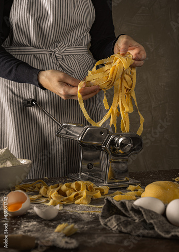 home made pasta machine with woman tagliatelli