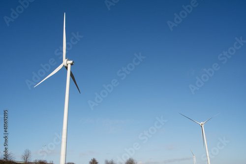 Modern windmills for electric power production with a clear blue sky in Arnhem in the Netherlands