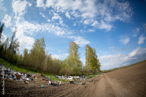 Piles of garbage in the field, garbage in the forest, environmental pollution, garbage on arable land.