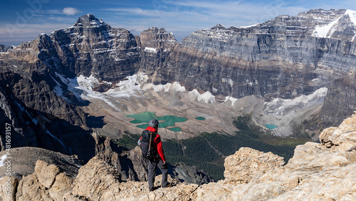 Climber standing on top of Mount Temple looking down to Paradise Valley, Banff National Park, Alberta, Canada.
