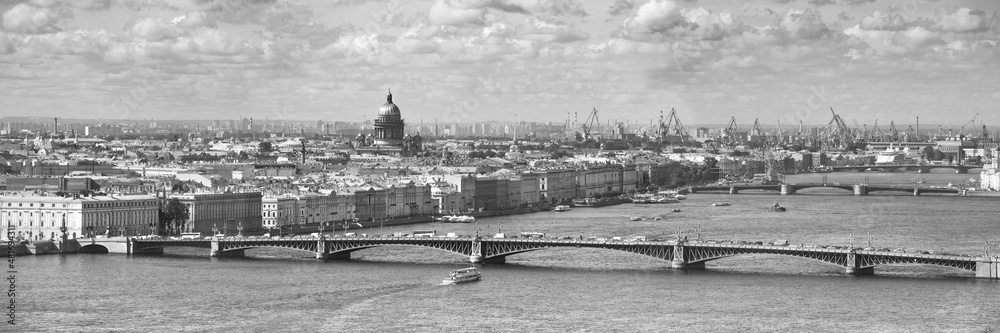 Aerial Panorama of the Neva river in Saint-Petersburg. Sky, clouds, roofs, spires. View of the Troitsky and Dvortsovy bridges