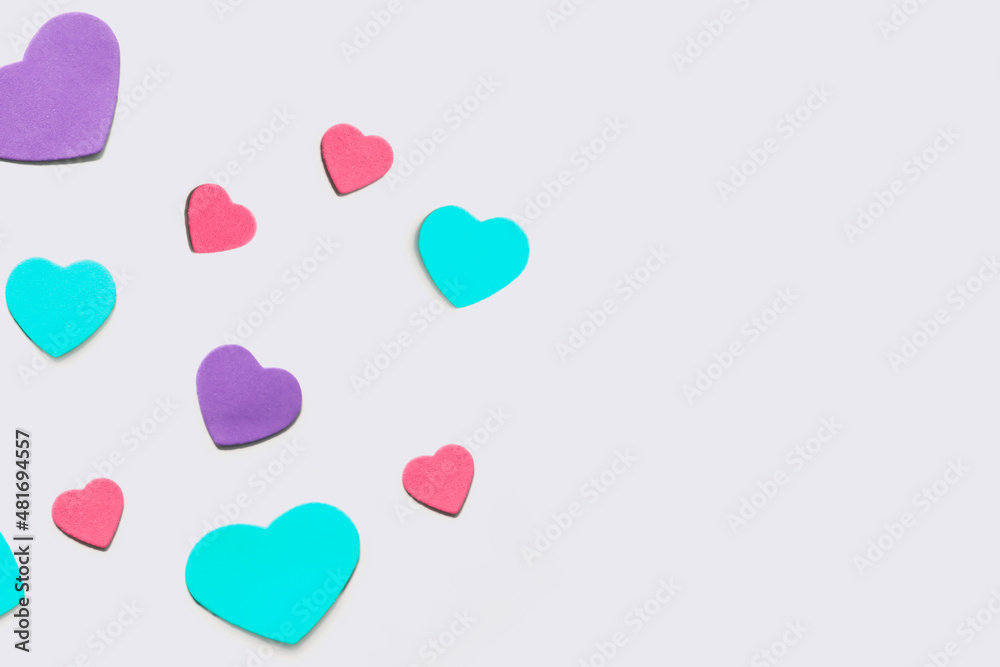 Valentine's Day background. Isolated multi-colored hearts on a white background. Valentine's Day background. Isolated multi-colored hearts on a white background.