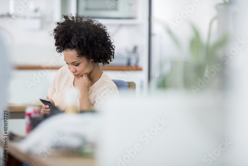 Texting at work. Real life businesspeople shot on location. Since these locations are the real thing, and not shot in an "office studio", high ISO levels are sometimes needed to catch the moment. The