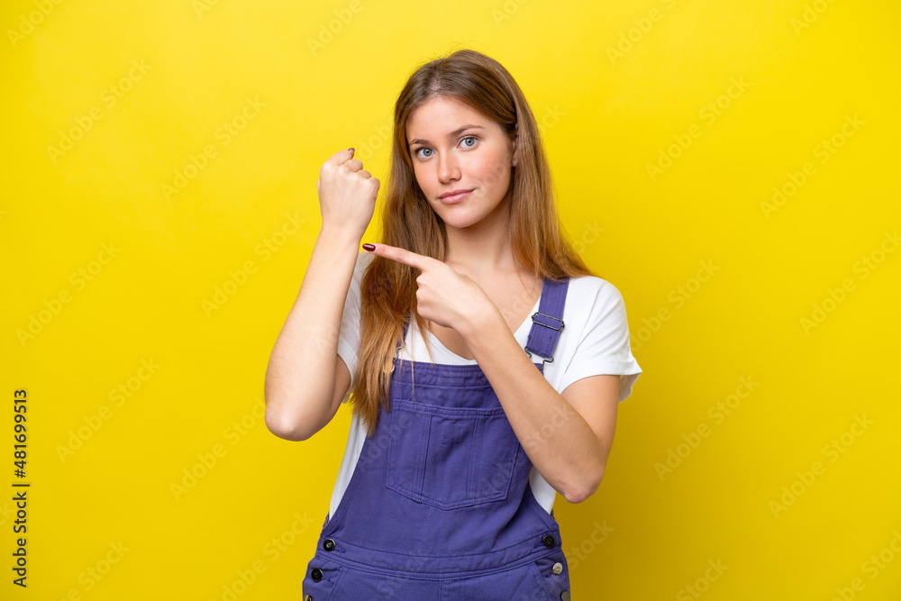 Young caucasian woman isolated on yellow background making the gesture of being late