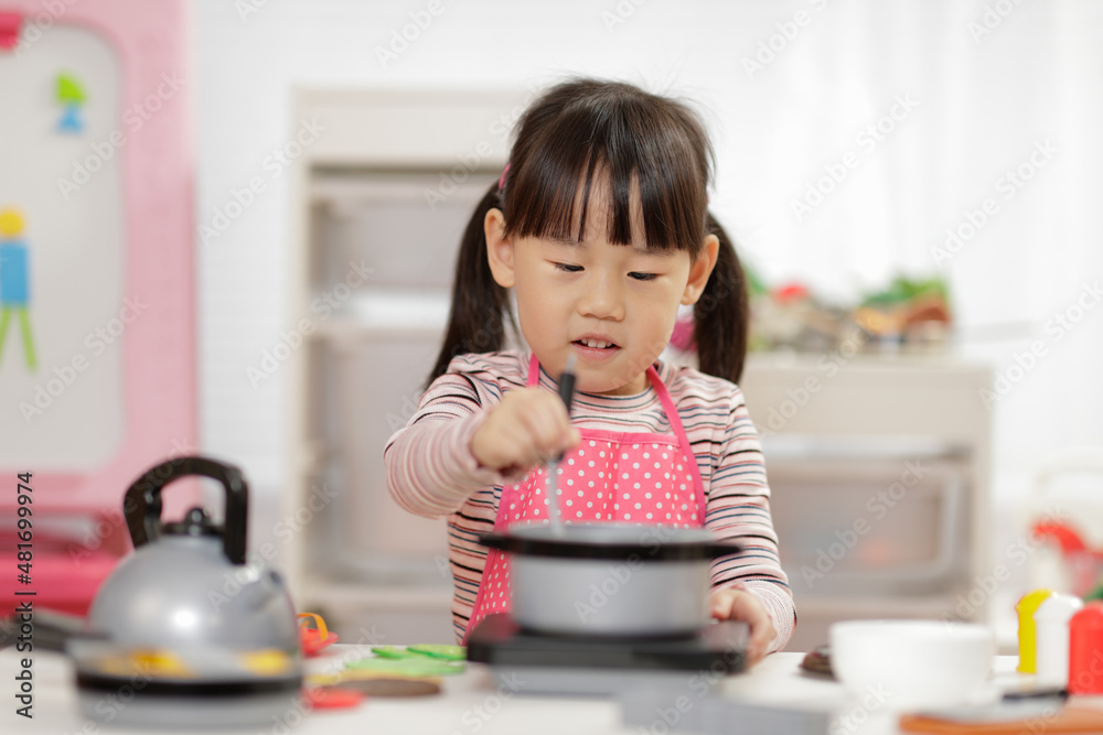 young girl pretend play food preparing at home young girl pretend play food preparing at home