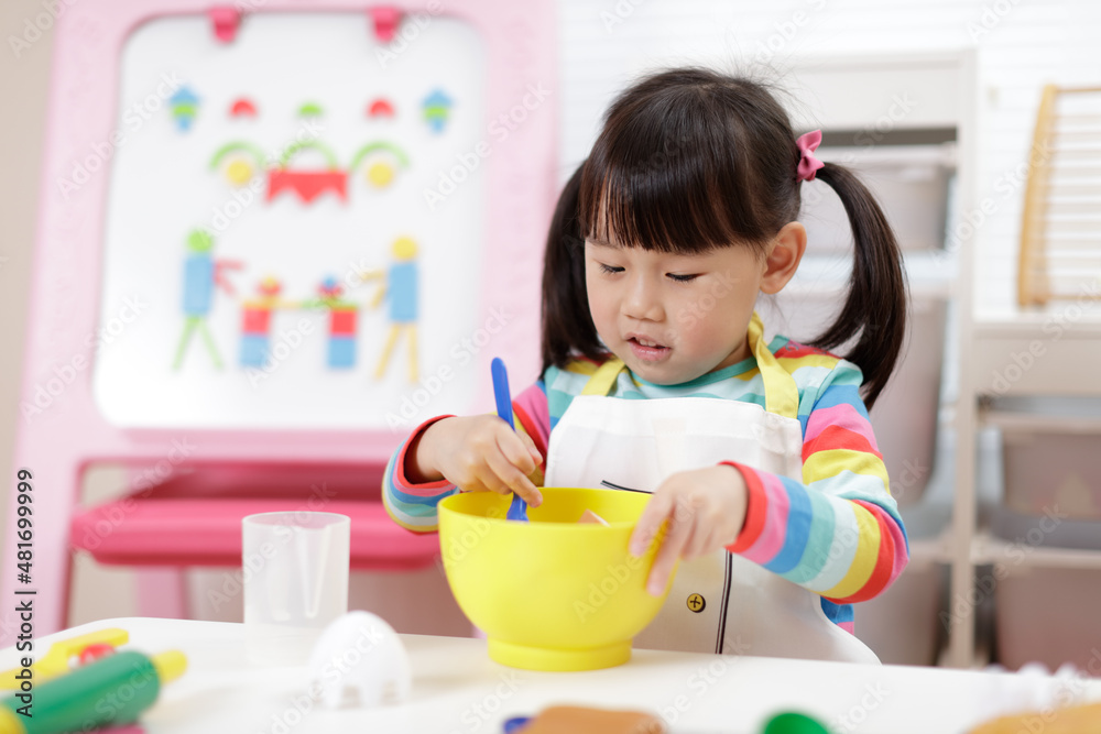 young girl pretend playing food preparing at home young girl pretend playing food preparing at home