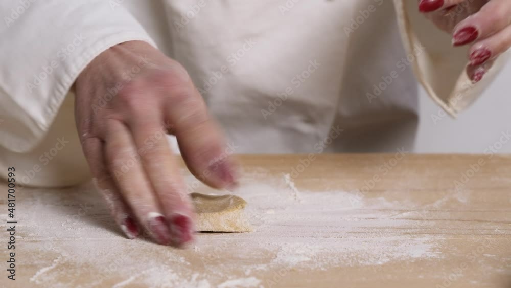 woman's hands roll out the dough with a rolling pin to prepare the pastry woman's hands roll out the dough with a rolling pin to prepare the pastry